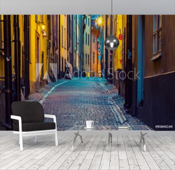 Bild på The narrow street of Gamla Stan - historic city old center of Stockholm at summer night with lanterns